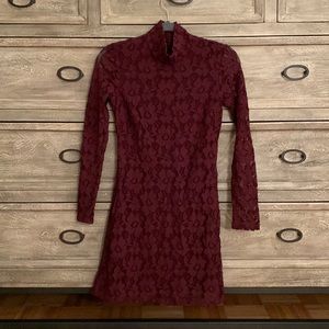 Wine colored mock neck lace dress with lined bodice. Zipper located back of neck